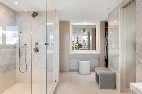 a bathroom with a double vanity sink mirror and shower