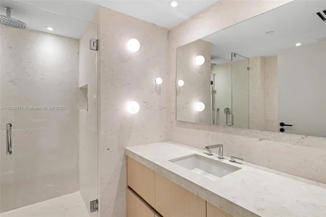 a bathroom with a toilet sink vanity and mirror