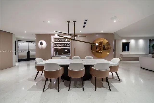 a living room with couches and kitchen view with wooden floor