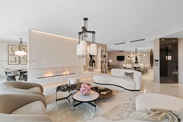 a living room with furniture and a chandelier