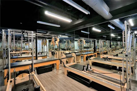 a view of a gym with lots of gym equipment