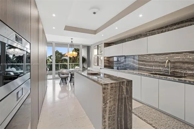 a kitchen with stainless steel appliances granite countertop a sink and cabinets