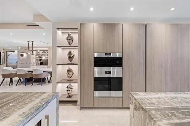 a living room with stainless steel appliances kitchen island granite countertop furniture and a view of living room