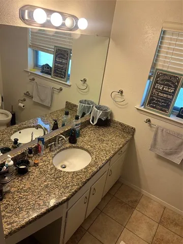 a bathroom with a shower and a sink