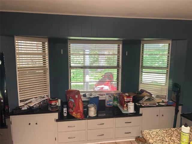 a kitchen with refrigerator and cabinets