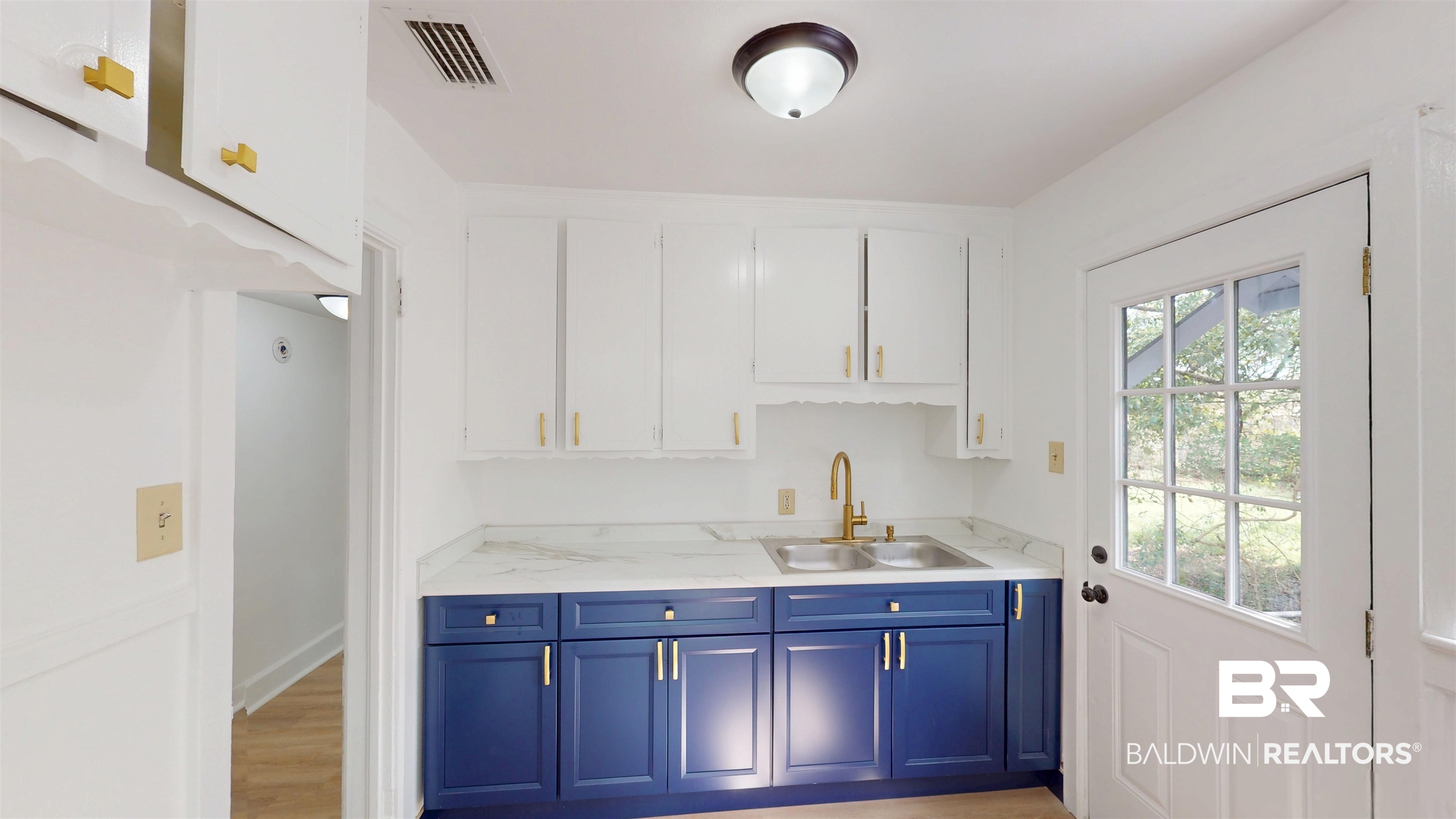 606 Shady Oak Drive Mobile, AL 36608 - Photo 6 of 14 Kitchen featuring two tone cabinetry and light wood finished floors