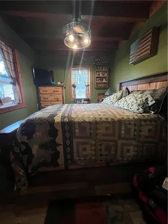 a bedroom with a bed and a chandelier
