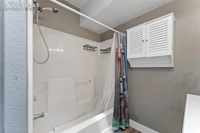 a bathroom with a shower and a window