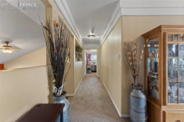 a view of a hallway with windows and stairs
