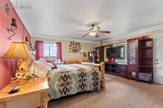 a bedroom with bed and a chandelier