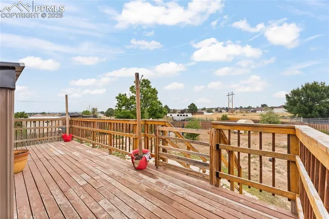 a view of balcony with wooden floor and fence