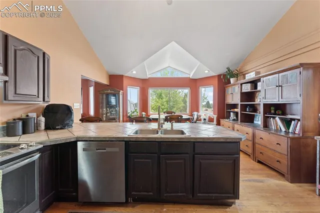 a kitchen with stainless steel appliances granite countertop a sink and cabinets