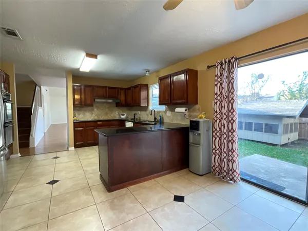 a kitchen with stainless steel appliances granite countertop a refrigerator and a stove