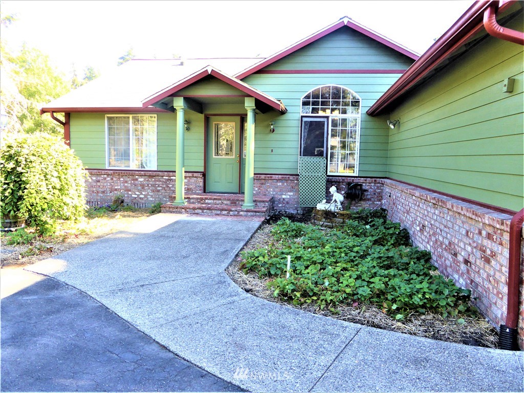 a front view of a house with a garden