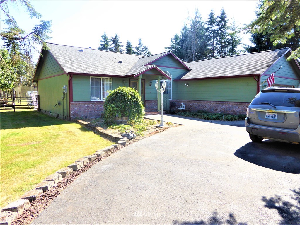 8209 177th Lane Southwest Rochester, WA 98579 - Photo 2 of 39 a view of a house with a yard and garage