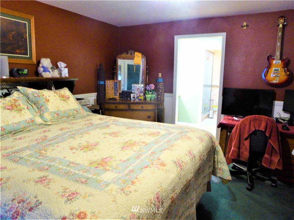 8209 177th Lane Southwest Rochester, WA 98579 - Photo 13 of 39 a bedroom with a bed and dresser