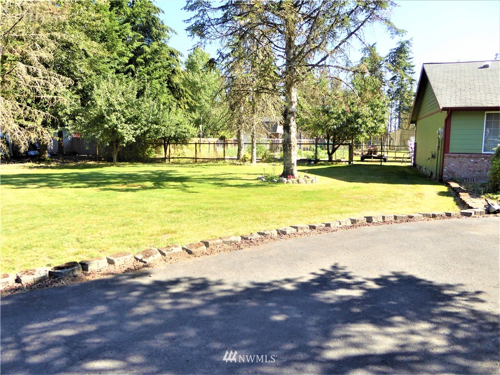 8209 177th Lane Southwest Rochester, WA 98579 - Photo 23 of 39 a view of a swimming pool with an outdoor space and seating area