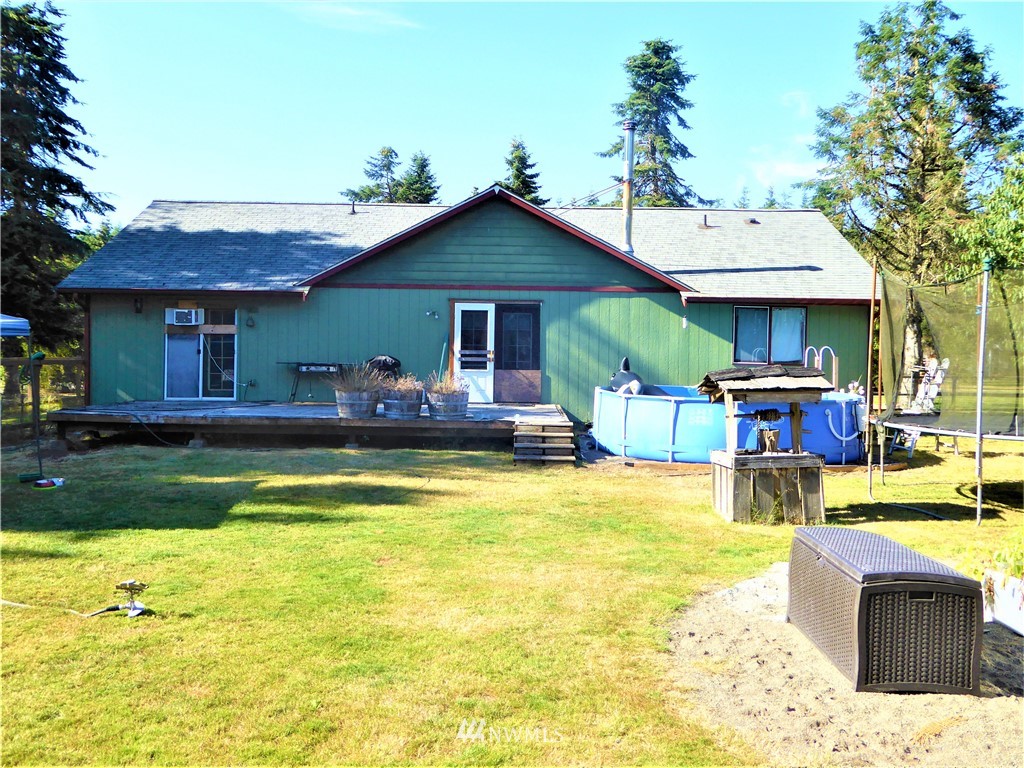 8209 177th Lane Southwest Rochester, WA 98579 - Photo 26 of 39 a view of a house with pool and chairs