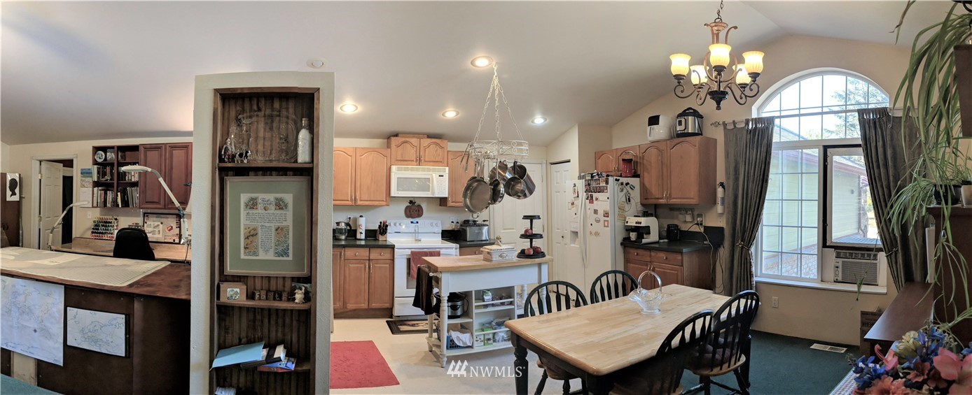 8209 177th Lane Southwest Rochester, WA 98579 - Photo 4 of 39 a view of a dining room with furniture and a chandelier