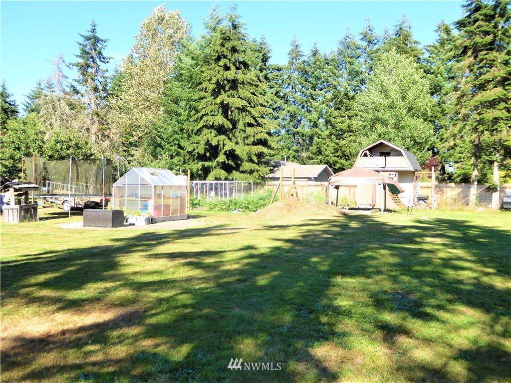 8209 177th Lane Southwest Rochester, WA 98579 - Photo 37 of 39 a front view of a house with a garden