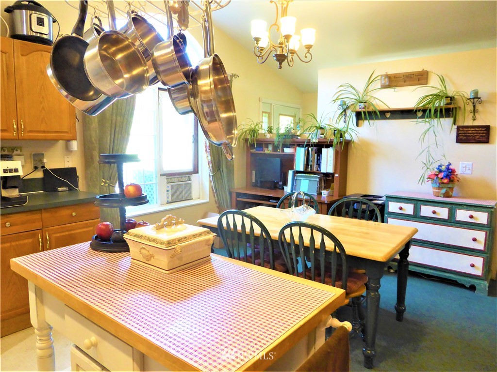 8209 177th Lane Southwest Rochester, WA 98579 - Photo 5 of 39 a dining room with furniture and a chandelier