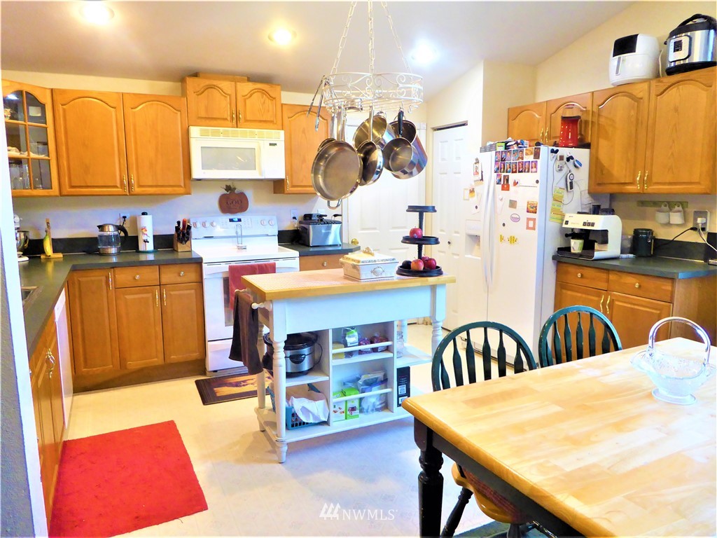 8209 177th Lane Southwest Rochester, WA 98579 - Photo 6 of 39 a kitchen with stainless steel appliances dining table and chairs