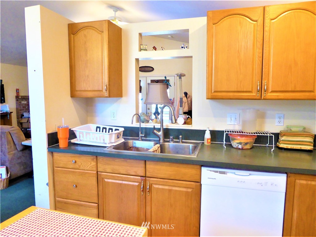8209 177th Lane Southwest Rochester, WA 98579 - Photo 7 of 39 a kitchen with stainless steel appliances granite countertop a sink and cabinets