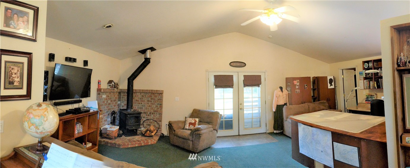 8209 177th Lane Southwest Rochester, WA 98579 - Photo 8 of 39 a living room with furniture and a flat screen tv