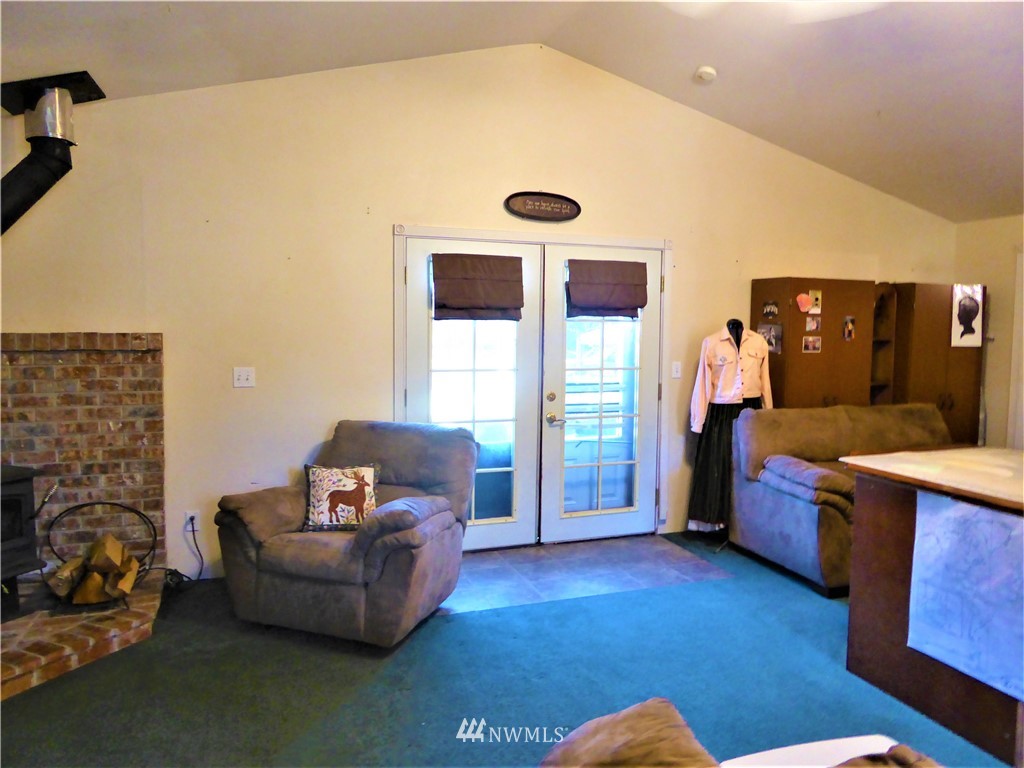 8209 177th Lane Southwest Rochester, WA 98579 - Photo 10 of 39 a living room with furniture and a fireplace