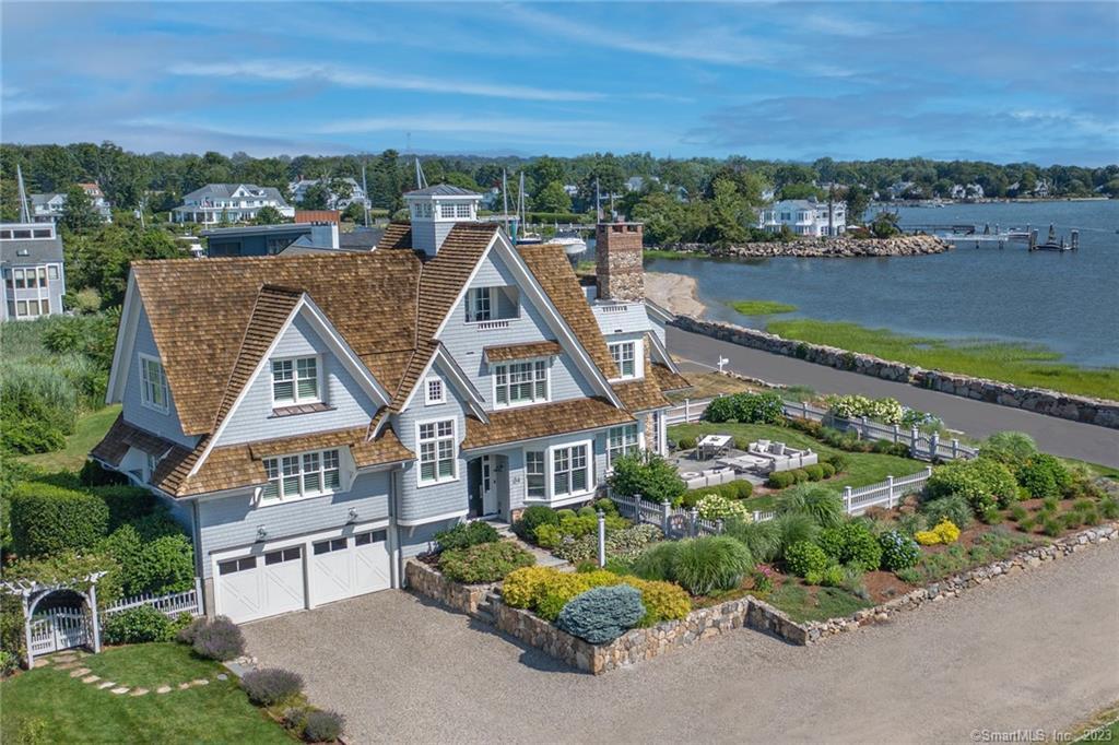 an aerial view of a house with a garden and lake view