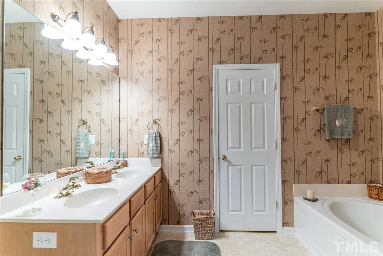 10423 Dapping Drive Raleigh, NC 27614 - Photo 14 of 25 a bathroom with a sink a mirror and a bathtub