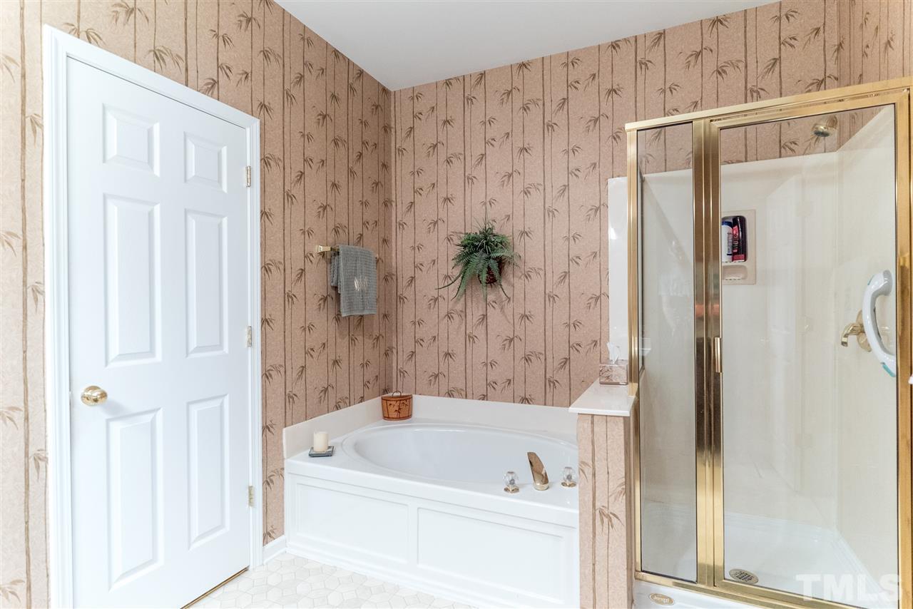 10423 Dapping Drive Raleigh, NC 27614 - Photo 15 of 25 a bathroom with a bathtub and a shower