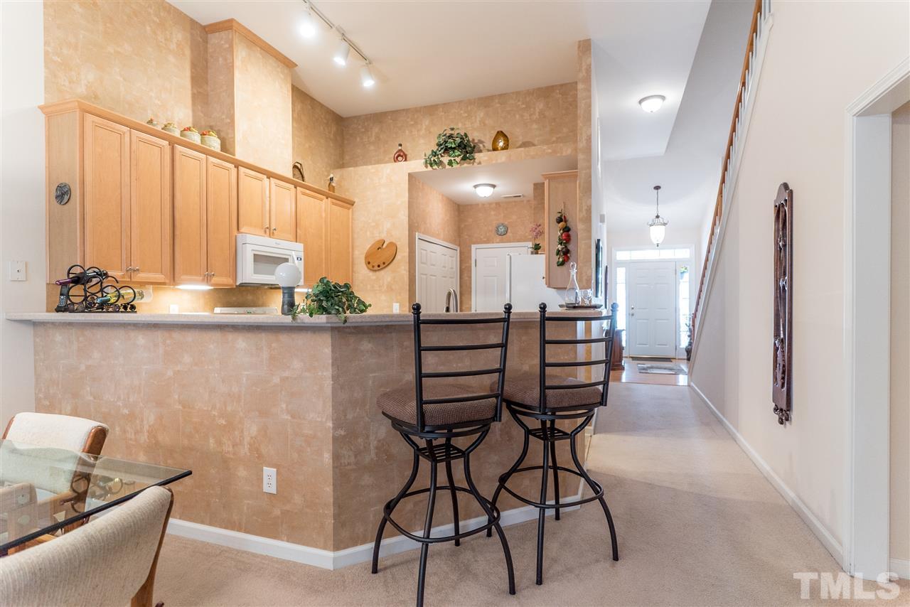 10423 Dapping Drive Raleigh, NC 27614 - Photo 4 of 25 a kitchen with a table chairs refrigerator and a sink
