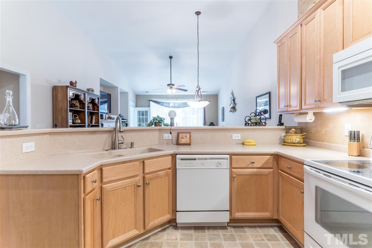 10423 Dapping Drive Raleigh, NC 27614 - Photo 7 of 25 a kitchen with a sink stove and cabinets