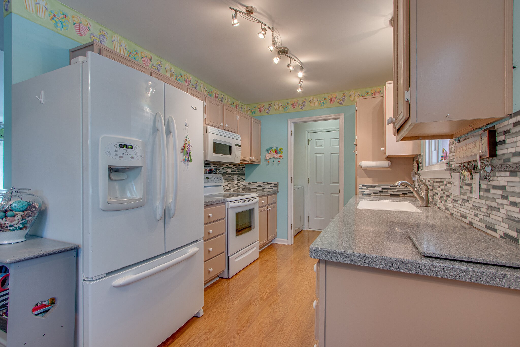 3624 Rutherford Drive Spring Hill, TN 37174 - Photo 10 of 33 a kitchen with stainless steel appliances granite countertop a refrigerator a oven and white cabinets with wooden floors