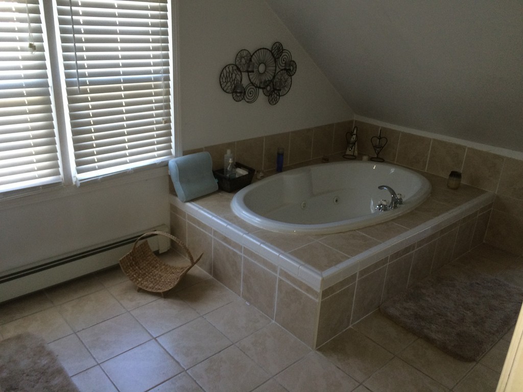 162 Allen Street Springfield, MA 01108 - Photo 14 of 19 a bath tub sitting in a bathroom next to a window