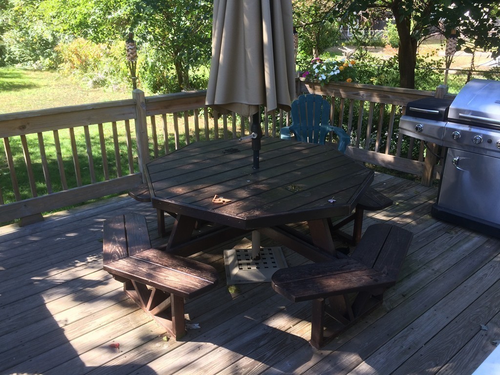 162 Allen Street Springfield, MA 01108 - Photo 17 of 19 a view of a patio with table and chairs a barbeque with wooden floor and fence