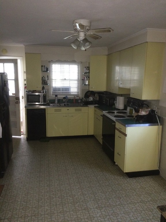 162 Allen Street Springfield, MA 01108 - Photo 9 of 19 a kitchen with a stove and a refrigerator