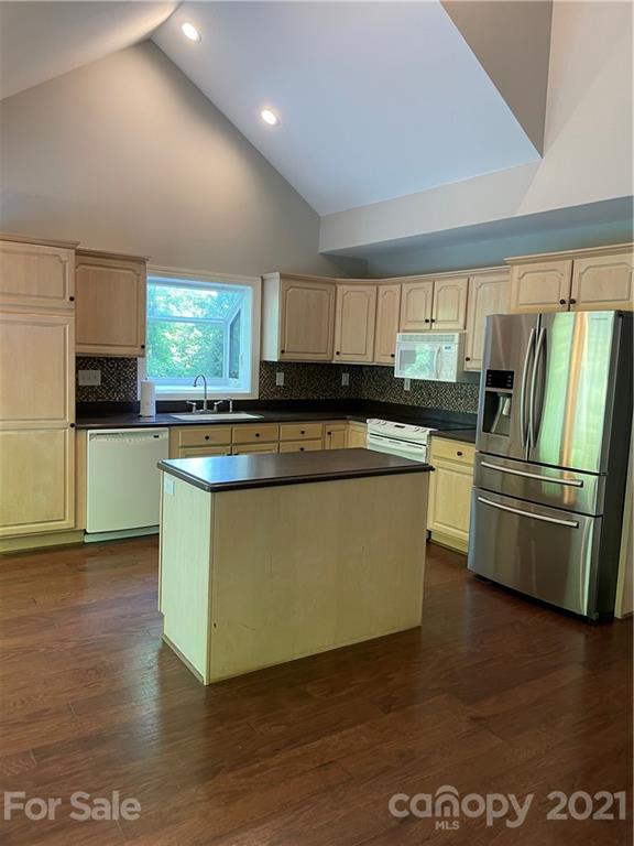550 Neel Road Salisbury, NC 28147 - Photo 8 of 22 a kitchen with stainless steel appliances granite countertop a stove top oven a sink and dishwasher with wooden floor