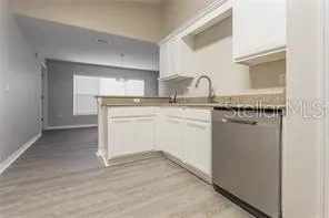 a kitchen with a sink cabinets and appliances