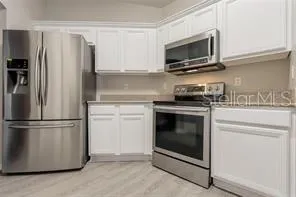 a kitchen with a stove microwave and refrigerator