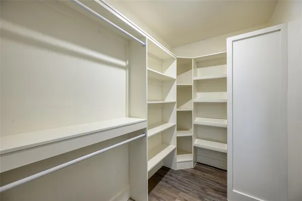 an empty room with a window and a ceiling fan