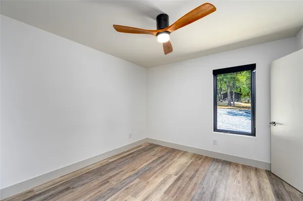 a view of a hallway with a ceiling fan