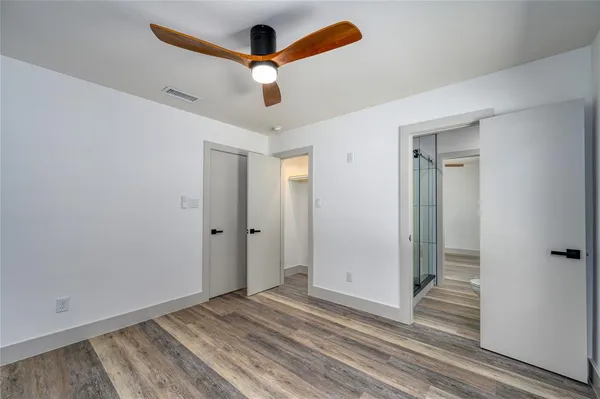 a bathroom with a granite countertop sink toilet mirror and shower