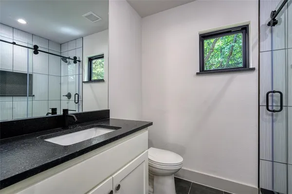 a bathroom with a shower and a mirror