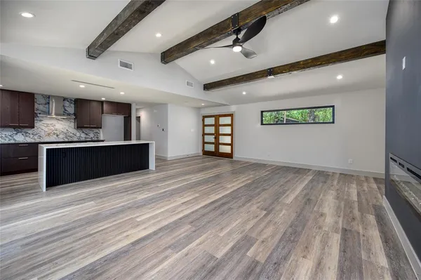 a view of kitchen that has a lot of cabinets in it