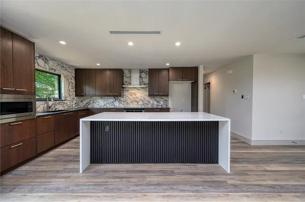 a kitchen with a refrigerator and a sink