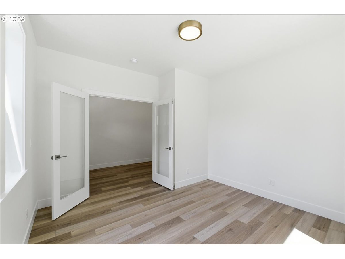 2147 Northeast Spitz Road Canby, OR 97013 - Photo 7 of 48 a view of an empty room with wooden floor