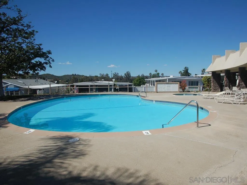 13300 East Los Coches Road East, Unit 68 El Cajon, CA 92021 - Photo 11 of 26 a view of a swimming pool with an outdoor seating and a yard