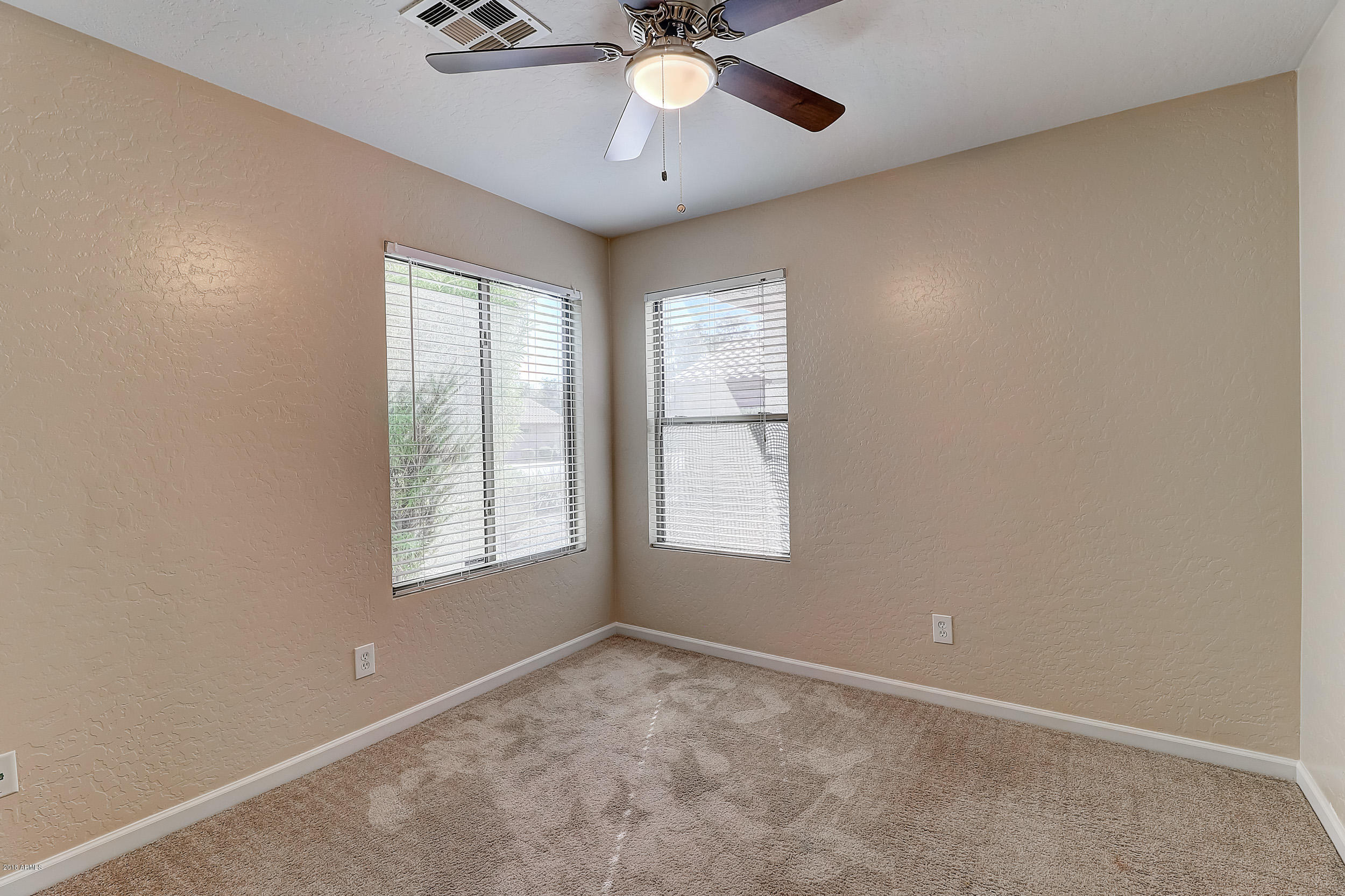 14726 West Calavar Road Surprise, AZ 85379 - Photo 15 of 24 an empty room with a window and a fan